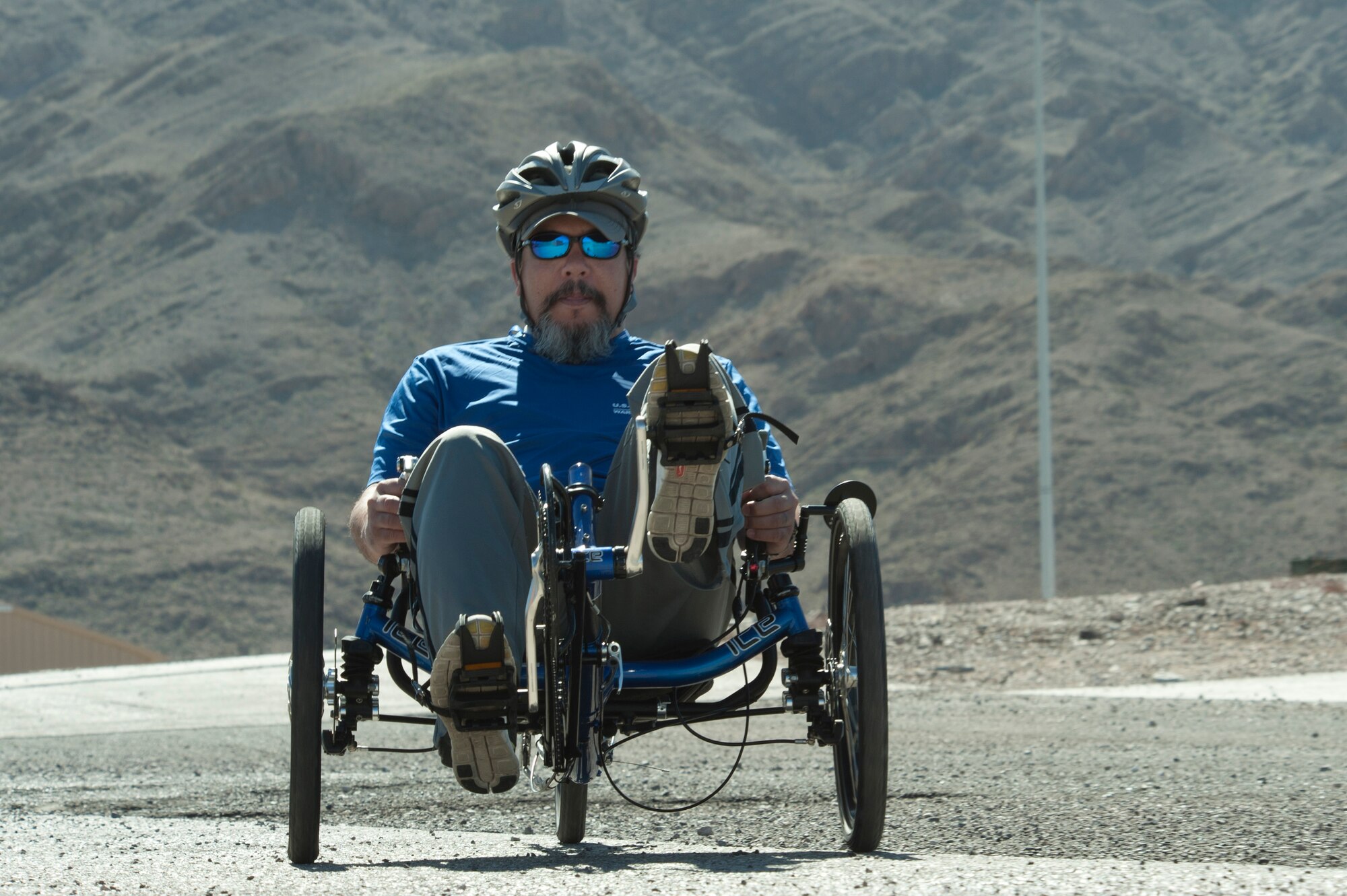 Mark Devesfruto, 2015 U.S. Air Force Trials cycling team member, peddles across a parking lot during a cycling fitting session at Nellis Air Force Base, Nev., Feb. 26, 2015. More than 100 wounded, ill or injured service men and women from around the country will compete for a spot on the 2015 U.S. Air Force Wounded Warrior Team which will represent the Air Force at the 2015 Warrior Games held in the fall and at adaptive sports events throughout the year. (U.S Air Force photo by Senior Airman Timothy Young)