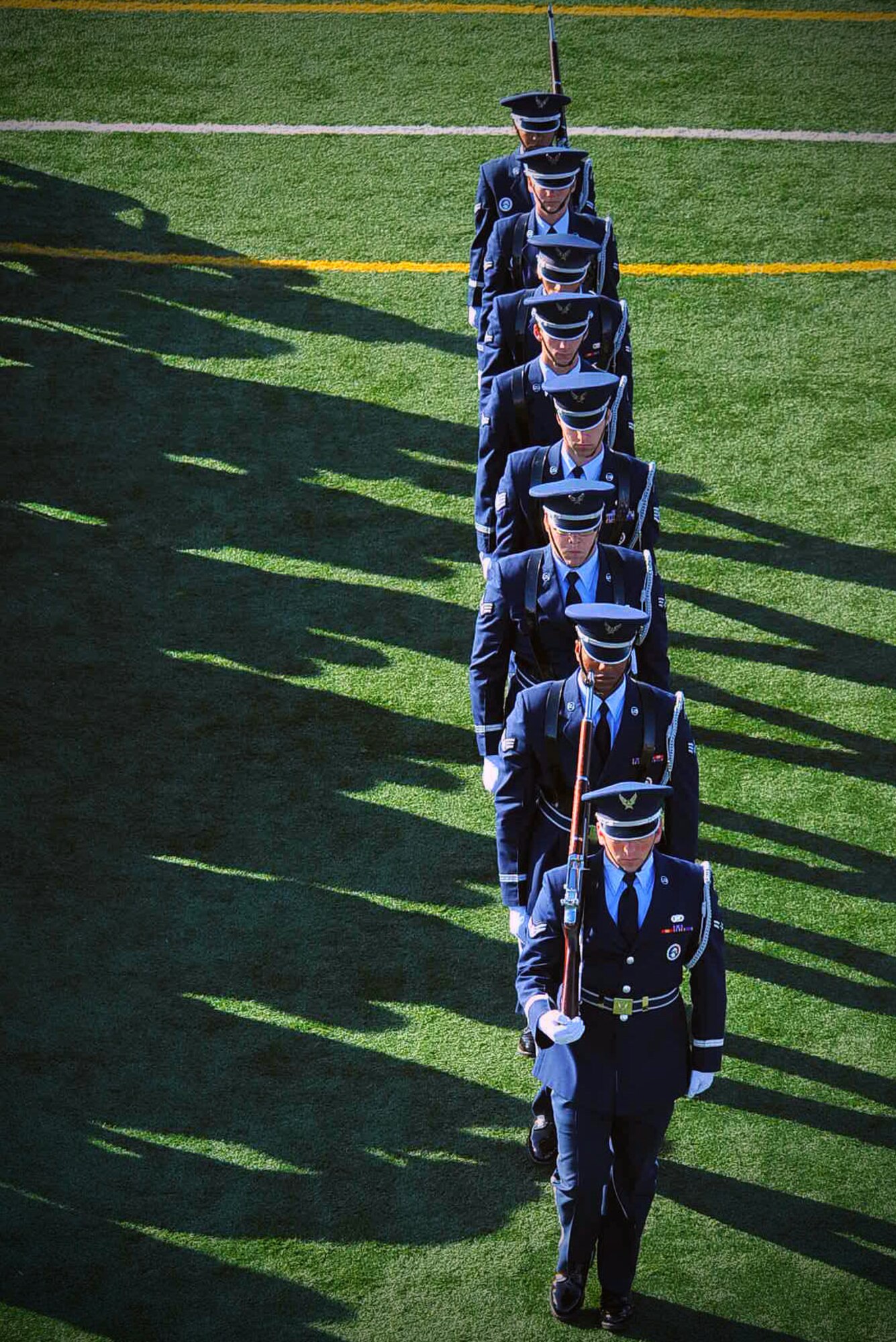 Members of the Nellis Air Force Base Honor Guard march after presenting the colors at the opening ceremony of the 2015 U.S. Air Force Trials at Nellis AFB, Nev. Feb. 27, 2015. The trials are an adaptive sports competition created to aid in the recovery of wounded warriors. (U.S. Air Force photo by Airman 1st Class Rachel Loftis)