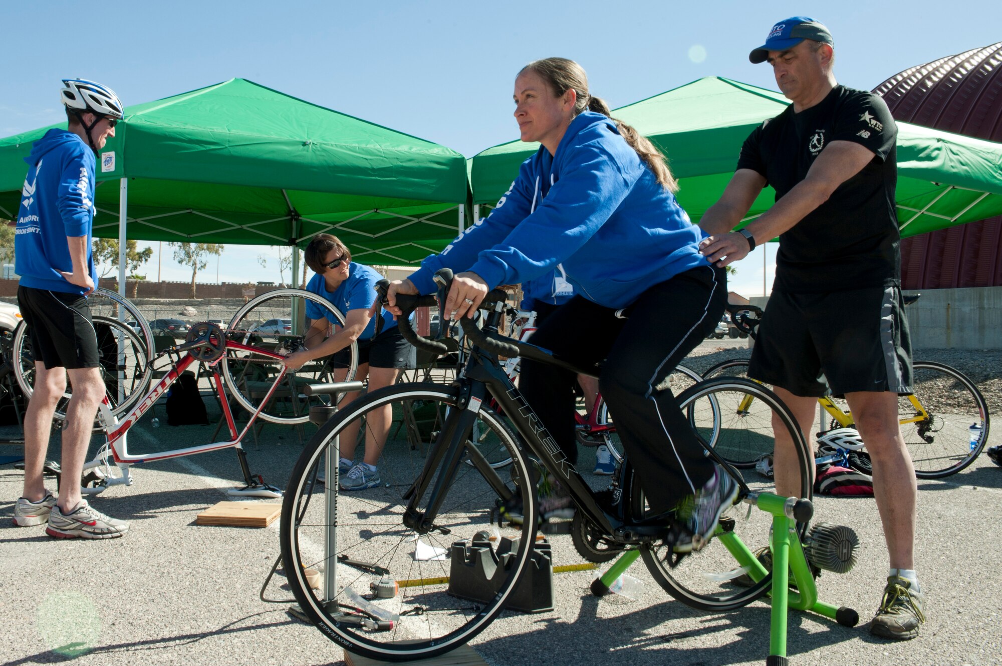 Master Sgt. Angie Blue, 2015 U.S. Air Force Trials cycling team member, tests a bike while Steve Byrnes, Air Force Trials cycling couch, checks for proper form and balance during a cycling fitting session at Nellis Air Force Base, Nev., Feb. 26, 2015. Cycling is one of 13 adapted sporting events scheduled to take place during this year’s trials. (U.S Air Force photo by Senior Airman Timothy Young)