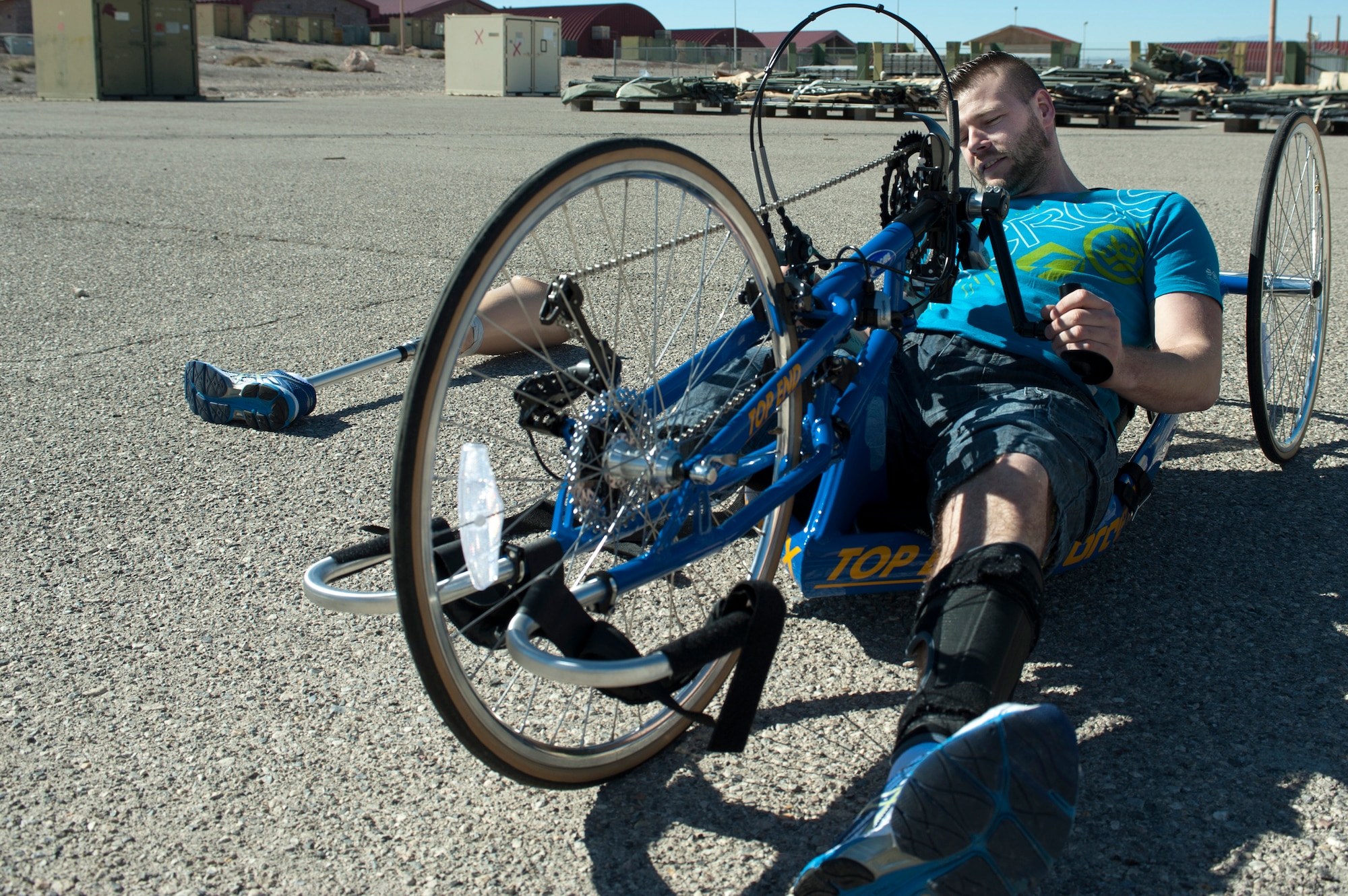 Garith Golightly, 2015 Help for Heroes cycling team member, adjusts his bike during a cycling fitting session at Nellis Air Force Base, Nev., Feb. 26, 2015. The athletes will be participating in adaptive athletic reconditioning, which are athletic activities modified to meet the abilities of injured or ill individuals. (U.S Air Force photo by Senior Airman Timothy Young)