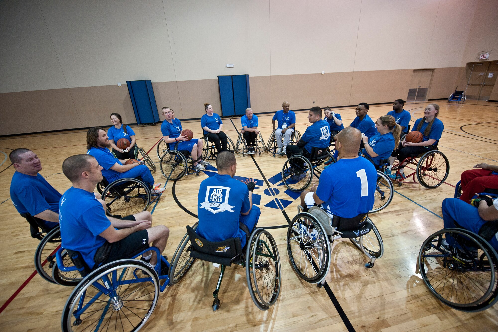 Members of the 2015 U.S. Air Force Trials wheelchair basketball team huddle together during a practice session at Nellis Air Force Base, Nev., Feb. 26, 2015. During the trials, participants will be competing for a spot on the 2015 U.S. Air Force Wounded Warrior Team, which will represent the Air Force at adaptive sports events throughout the year.  (U.S. Air Force photo by Staff Sgt. Siuta B. Ika)