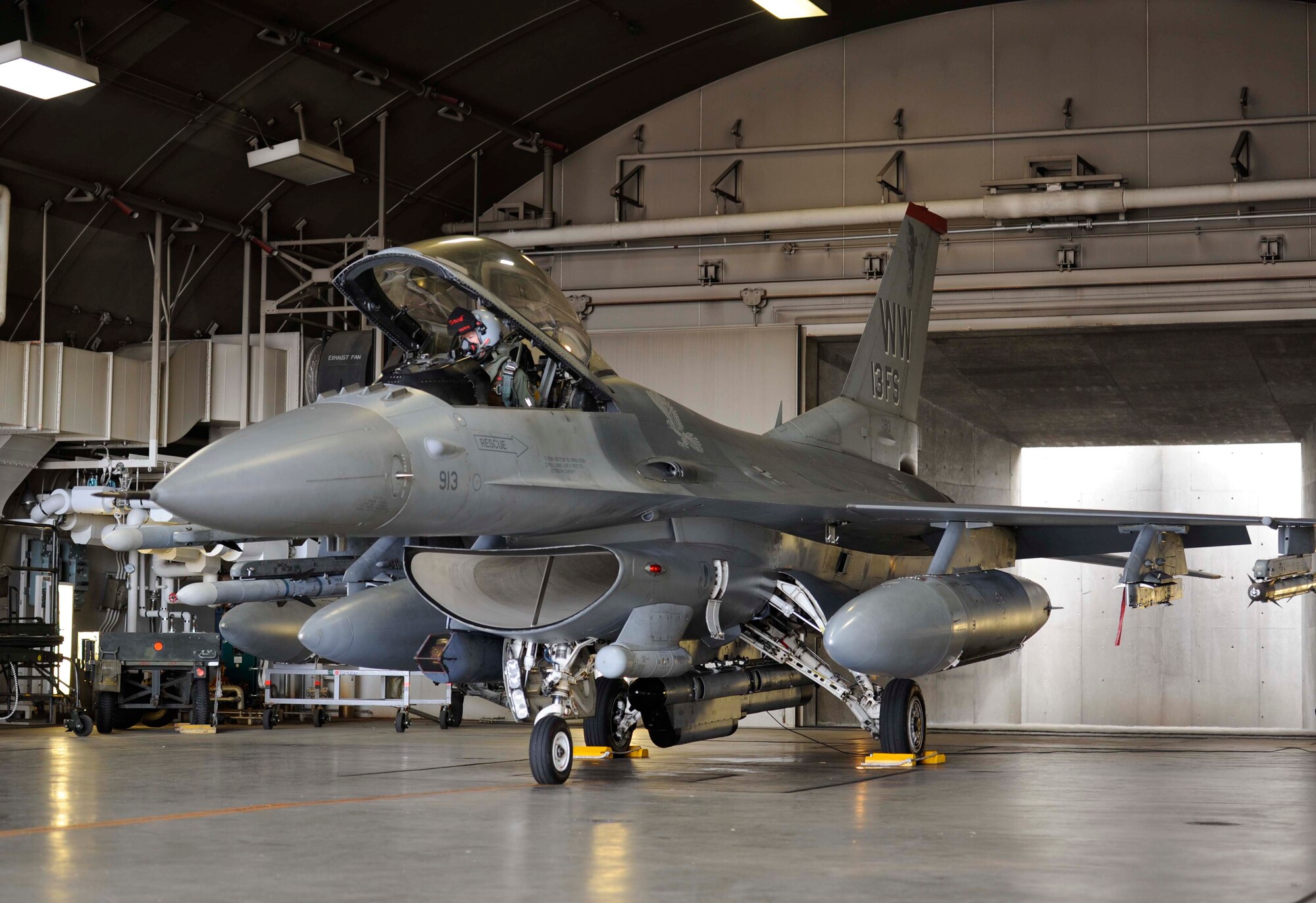 U.S. Air Force Lt. Col. Kristopher Struve, 13th Fighter Squadron commander, closes the cockpit of an F-16 Fighting Falcon at Misawa Air Base, Japan, March 1, 2015. Struve geared the aircraft for take-off as part of exercise Beverly Sunrise 15-2, which tested Misawa Airmen to ensure they are able to react to real-world scenarios. (U.S. Air Force photo by Airman 1st Class Jordyn Rucker/Released)