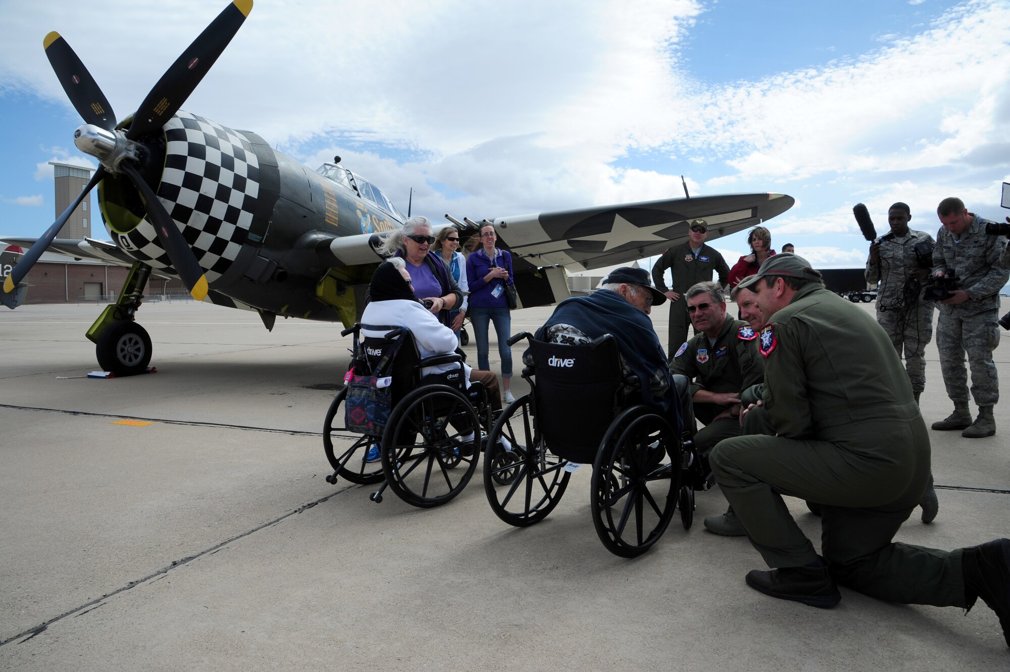 Retired Chief Warrant Officer 2 Robert Hertel, 92-year-old World War II veteran, is greeted by P-47 Thunderbolt Heritage Flight pilots, and U.S. Air Force General Hawk Carlisle, Commander of Air Combat Command, at Davis-Monthan Air Force Base, Ariz., Feb. 28, 2015. Hertel was given the opportunity to visit the aircraft he flew during WWII, up-close and personal, during the 2015 Heritage Flight Training and Certification Course. (U.S. Air Force Photo by Staff Sgt. Courtney Richardson)