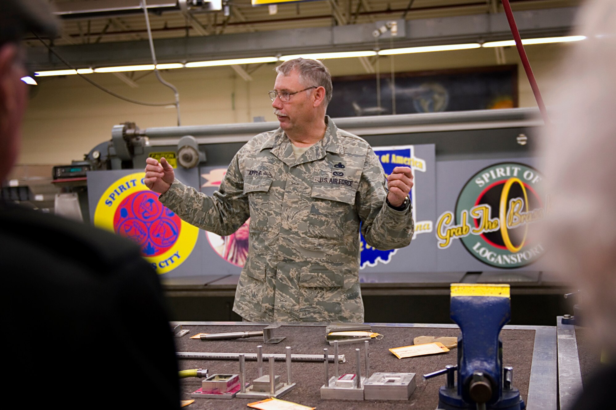 Master Sgt. Scott Apple, 434th Maintenance Squadron structural maintenance craftsman, describes aircraft structural repairs conducted by their shop to a group of Grissom Community Council members during a tour at Grissom Air Reserve Base, Ind., Feb. 13, 2015. The 434th Aircraft Maintenance Squadron fabrication flight manufactures and repairs all aircraft parts that cannot be procured through a supply source. (U.S. Air Force photo/Tech. Sgt. Benjamin Mota)
