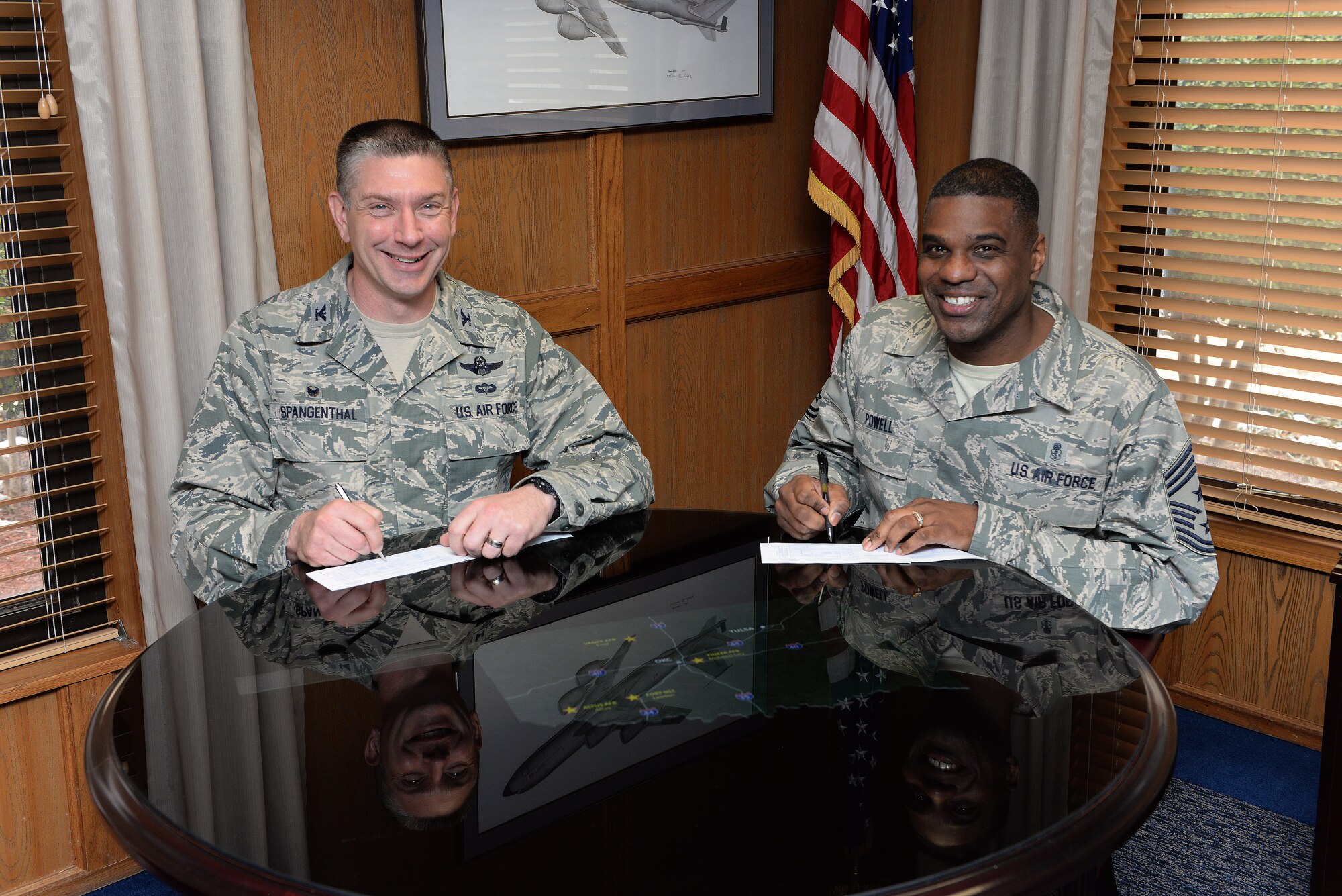 ALTUS AIR FORCE BASE, Okla. – U.S. Air Force Col. Bill Spangenthal, 97th Air Mobility Wing commander and Chief Master Sgt. James Powell, 97th AMW command chief, sign their 2015 Air Force Assistance Fund donation forms, March 2, 2015. The money collected by the campaign will fund four affiliated charities: the Air Force Villages Charitable Foundation, the Air Force Aid Society, General and Mrs. Curtis E. LeMay Foundation and the Air Force Enlisted Village. (U.S. Air Force photo by Airman 1st Class Megan E. Acs/Released)