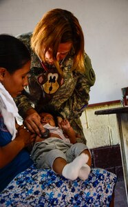 U.S. Army Lt. Col. Karen Rutherford, Joint Task Force-Bravo Medical Element medical provider, checks an infant’s breathing during a Medical Readiness Training Exercise in La Blanca, Guatemala, Feb. 26, 2015.  Together JTF-Bravo, the Guatemalan Ministry of Health and members of the Guatemalan military came together to help provide medical care to over 1,200 Guatemalan citizens in need. During the two-day exercise, the JTF-Bravo team and preventative medicine specialists from the Guatemalan Ministry of Health educated, screened and treated over 1,200 patients. (U.S. Air Force Photo/Tech. Sgt. Heather Redman)