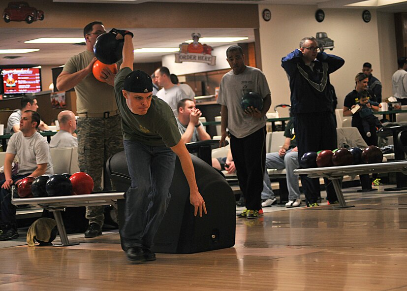 Senior Airman Brett Davis, 319th Security Forces Squadron combat arms journeyman, starts in motion to bowl during the 2015 Winter Bash Feb. 26 on Grand Forks Air Force Base, N.D. Davis bowled three games, with the total scores of 158, 169 and 154. (U.S. Air Force photo/Senior Airman Xavier Navarro)  