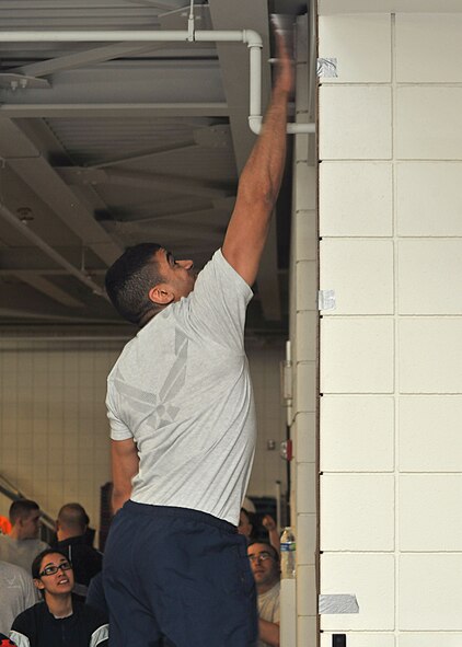 Senior Airman Abel Trejo, 319th Logistics Readiness Squadron fuels journeyman, launches up 32 inches in the air during the standing board jump for the fitness combine event at the 2015 Winter Bash Feb. 26 on Grand Forks Air Force Base, N.D. Trejo won first place overall at the 40 meter dash broad jump and vertical jump. (U.S. Air Force photo/Senior Airman Xavier Navarro) 