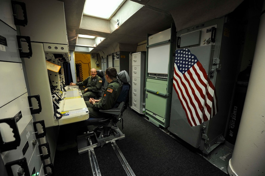 1st Lt. Kris Riedman, 742nd Missile Squadron intercontinental ballistic missile combat crew commander and 2nd Lt. Kameron Kantor, 742nd MS ICBM combat crew deputy, work side-by-side in the launch capsule of the Oscar 1 missile alert facility near Mohall, N.D., Jan. 9, 2015. While stationed in the capsule, Riedman and Kantor respond via phone to top side alarms and also report their status to the crews above ground. (U.S. Air Force photo/Senior Airman Stephanie Morris)