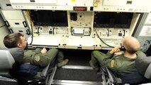 (left) 1st Lt. Kris Riedman, 742nd Missile Squadron intercontinental ballistic missile combat crew commander and (right) 2nd Lt. Kameron Kantor, 742nd MS ICBM combat crew deputy, answer phones in the launch capsule of the Oscar 1 missile alert facility near Mohall, N.D., Jan. 9, 2015. While stationed in the capsule, Riedman and Kantor respond via phone to top side alarms and also report their status to the crews above ground. (U.S. Air Force photo/Senior Airman Stephanie Morris)