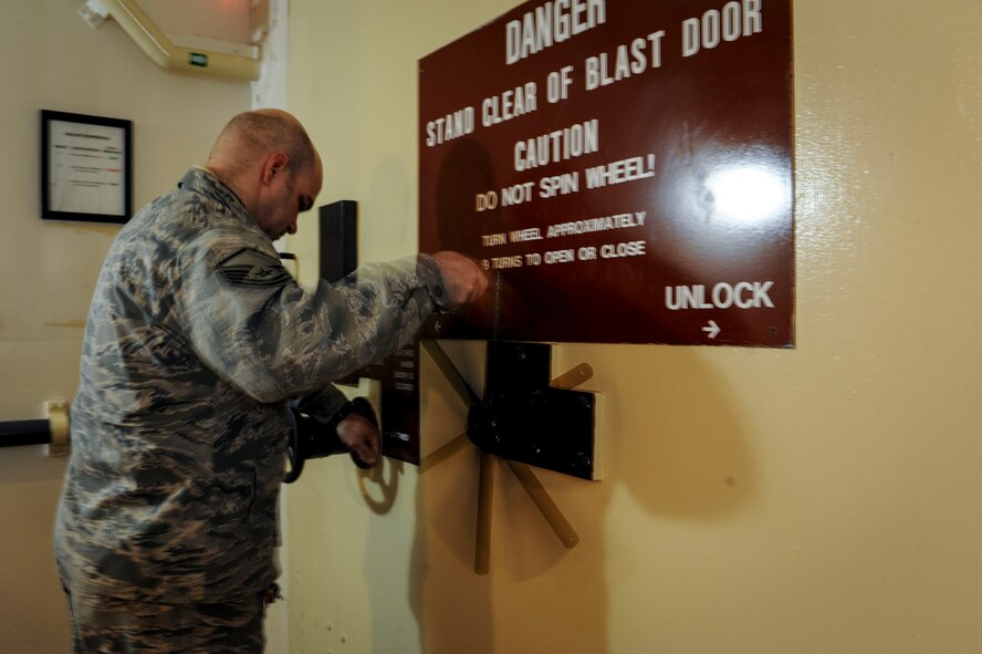 Master Sgt. John Stinson, 742nd Missile Squadron facility manager, opens a blast door in the Oscar 1 missile alert facility near Mohall, N.D., Jan. 9, 2015. As facility manager Stinson is responsible for the overall upkeep of the structures at Oscar 1 as well as overseeing the water, heat and other utilities. (U.S. Air Force photo/Senior Airman Stephanie Morris)