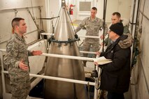 David Taylor, Times of London editor, speaks with 91st Maintenance Operations Squadron Airmen on Minot Air Force Base, N.D., Jan. 7, 2014. The Airmen gave Taylor a tour of U-01 and discussed their everyday duties. (U.S. Air Force photo/Airman 1st Class Sahara L. Fales)
