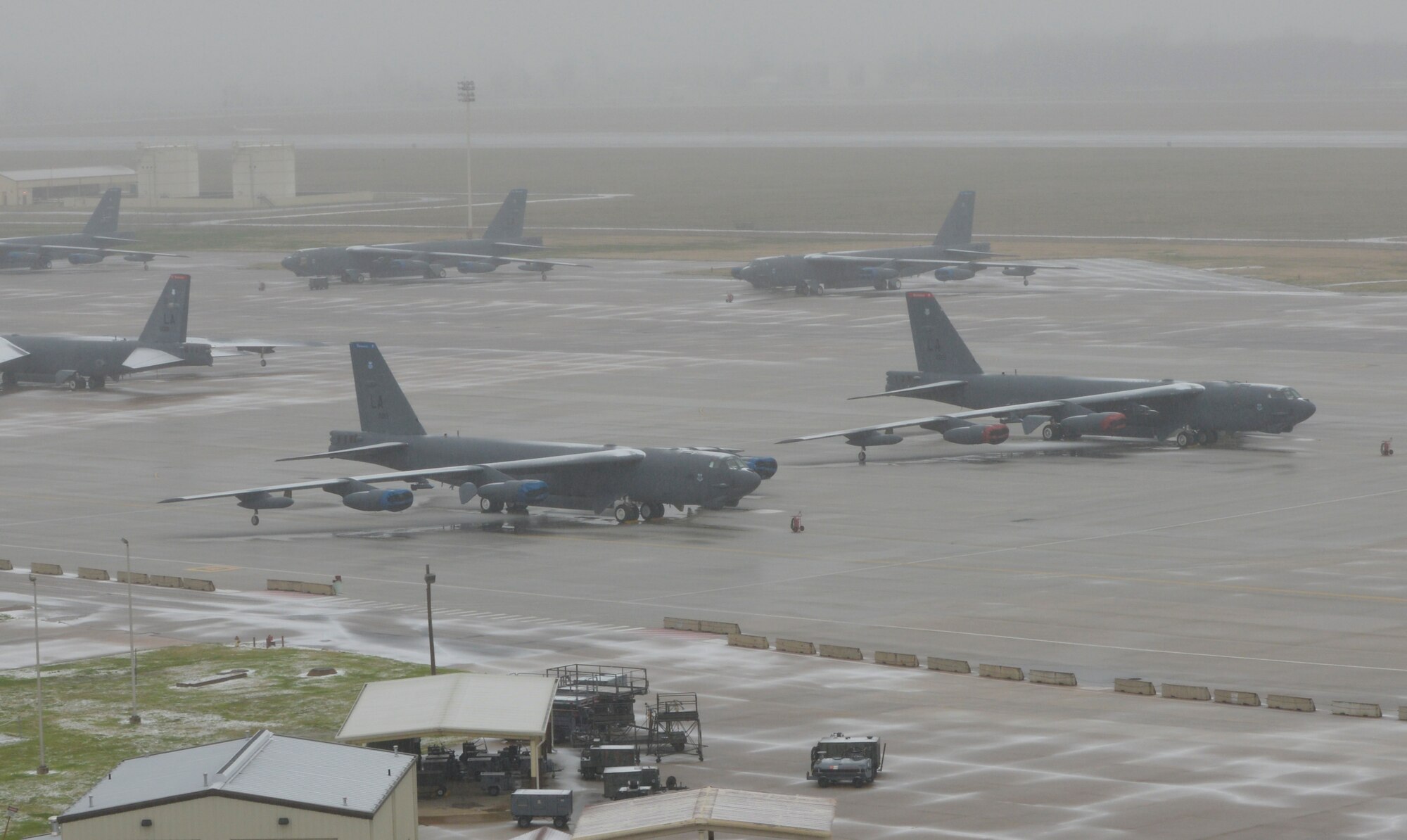 B-52H Stratofortresses rest on the flightline after a winter storm on Barksdale Air Force Base, La., Feb. 23, 2015. Barksdale was hit with half an inch of freezing rain Feb 23 and 2.25 inches of snow Feb. 25, reducing base operations to minimal manning. The base averages one day of snow and 1.4 inches of total snowfall per year. (U.S. Air Force photo/Senior Airman Benjamin Raughton)