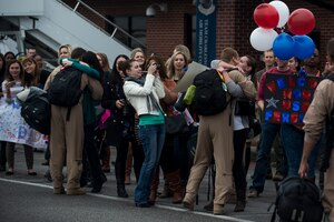 More than 100 family members welcome home Airmen from the 16th Airlift Squadron and the 437th Operations Support Squadron out on the flightline March 2, 2015, at Joint Base Charleston, S.C, during the unit’s redeployment from Southwest Asia. Aircrews from the 16th AS flew 1,902 sorties, logged more than 4,400 combat flying hours and airlifted more than 71 million pounds of cargo and 17,500 personnel during their two-month deployment.  (U.S. Air Force photo/Senior Airman Jared Trimarchi)