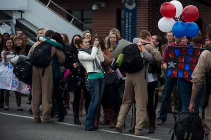 More than 100 family members welcome home Airmen from the 16th Airlift Squadron and the 437th Operations Support Squadron out on the flightline March 2, 2015, at Joint Base Charleston, S.C, during the unit’s redeployment from Southwest Asia. Aircrews from the 16th AS flew 1,902 sorties, logged more than 4,400 combat flying hours and airlifted more than 71 million pounds of cargo and 17,500 personnel during their two-month deployment.  (U.S. Air Force photo/Senior Airman Jared Trimarchi)