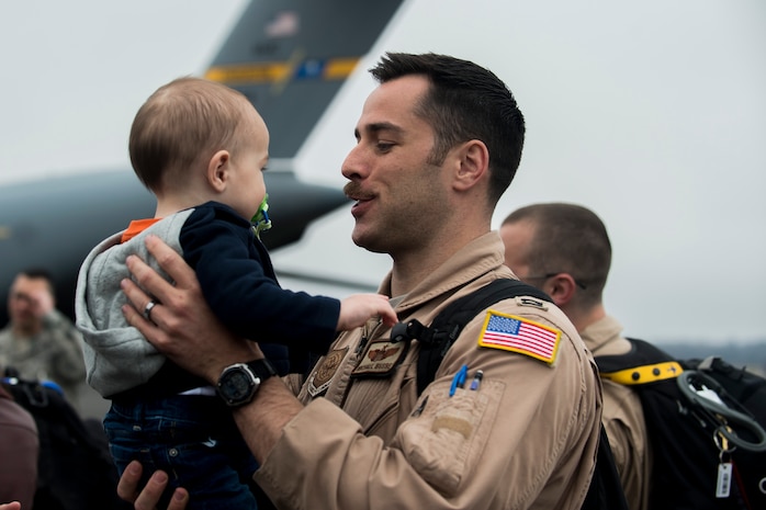 Capt. Michael Busse reunites with his son March 2, 2015, at Joint Base Charleston, S.C, during the 16th Airlift Squadron’s redeployment from Southwest Asia. Aircrews from the 16th AS flew 1,902 sorties, logged more than 4,400 combat flying hours and airlifted more than 71 million pounds of cargo and 17,500 personnel during their two-month deployment.  (U.S. Air Force photo/Senior Airman Jared Trimarchi)