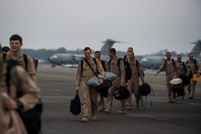 Airmen from the 16th Airlift Squadron arrive home, March 2, 2015, at Joint Base Charleston, S.C, during their redeployment from Southwest Asia. Aircrews from the 16th AS flew 1,902 sorties, logged more than 4,400 combat flying hours and airlifted more than 71 million pounds of cargo and 17,500 personnel during their two-month deployment.  (U.S. Air Force photo/Senior Airman Jared Trimarchi) 