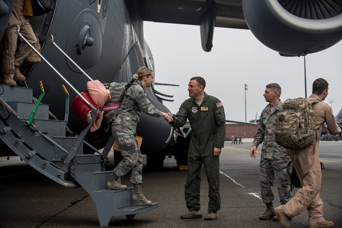 Col. John Lamontagne, 437th Airlift Wing commander and Chief Master Sgt. Shawn Hughes, 437th AW command chief, welcome home Airmen from the 16th Airlift Squadron  and the 437th Operations Support Squadron, March 2, 2015, at Joint Base Charleston, S.C, during their redeployment from Southwest Asia. Aircrews from the 16th AS flew 1,902 sorties, logged more than 4,400 combat flying hours and airlifted more than 71 million pounds of cargo and 17,500 personnel during their two-month deployment.  (U.S. Air Force photo/Senior Airman Jared Trimarchi) 