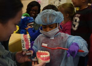 Aahmir Elmore practices tooth brushing techniques during a demonstration at the Child Development Center for National Children’s Dental Health Month on Joint Base Andrews, Md., Feb. 26, 2015. The 779th Dental Squadron held an interactive demonstration to educate JBA children on dental hygiene. (U.S. Air Force photo/ Senior Airman Nesha Humes)