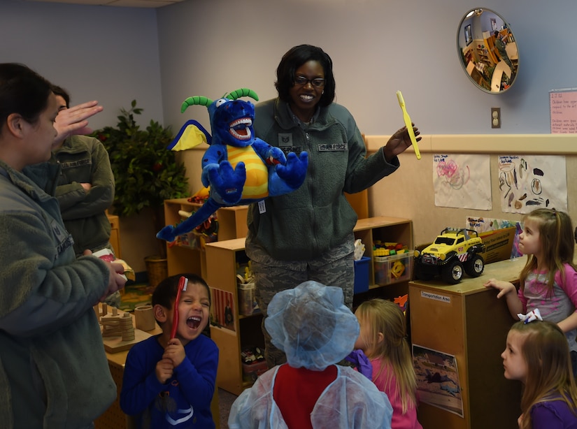 Tech Sgt. Tina Phelps-Prince, 779th Dental Squadron NCO in Charge of preventive dentistry, teaches children at the Child Development Center proper dental hygiene for National Children’s Dental Health Month on Joint Base Andrews, Md., Feb. 26, 2015. The 779th DS visited children at all three CDCs. (U.S. Air Force photo/ Senior Airman Nesha Humes)