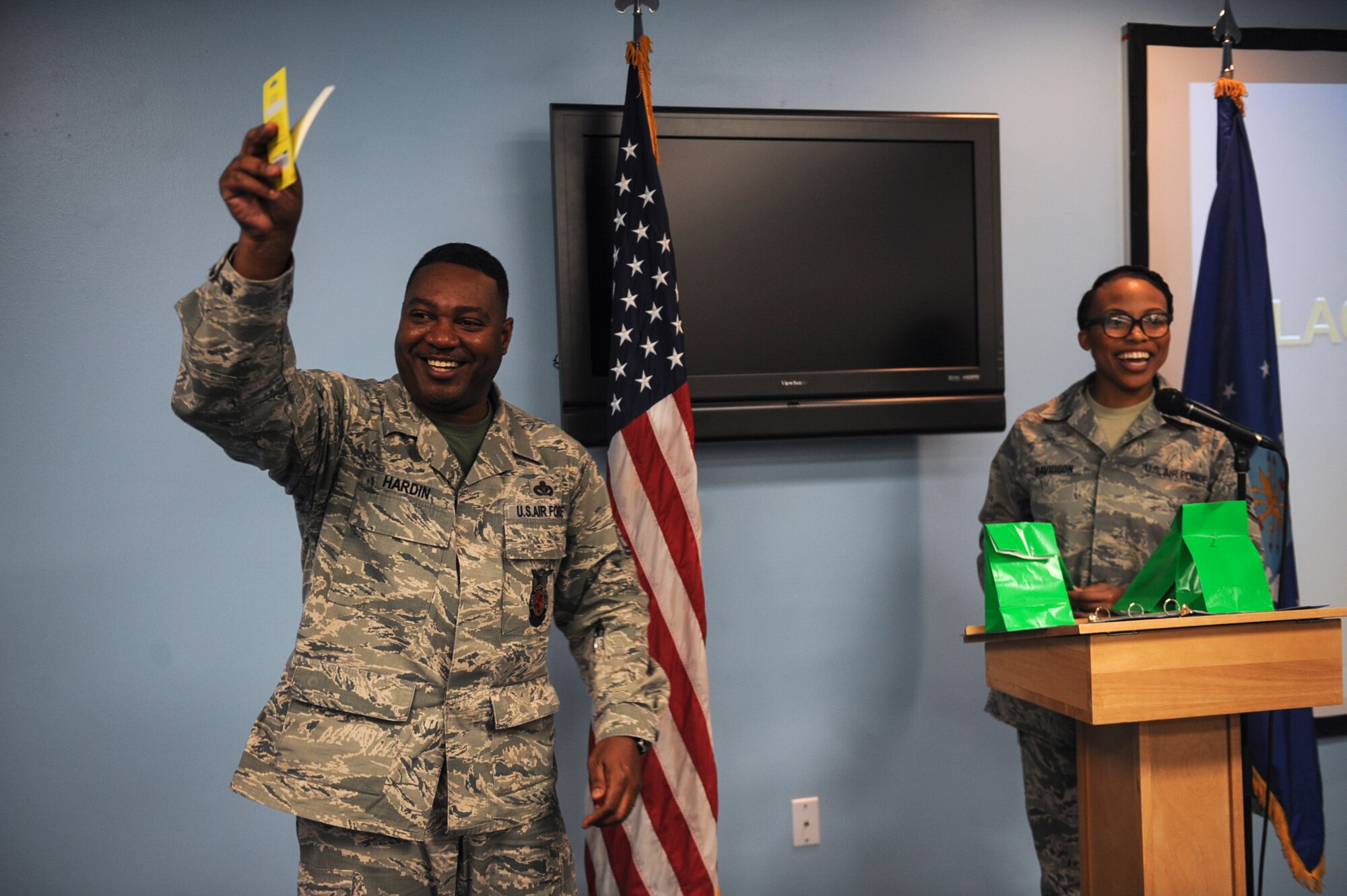 U.S. Air Force Chief Master Sgt. Will Hardin, 23d Civil Engineer Squadron fire prevention chief, celebrates after winning a door prize during the Black History Month luncheon Feb. 27, 2015, at Moody Air Force Base, Ga. Five random recipients won door prizes at the end of the luncheon. (U.S. Air Force photo by Senior Airman Olivia Bumpers/Released)