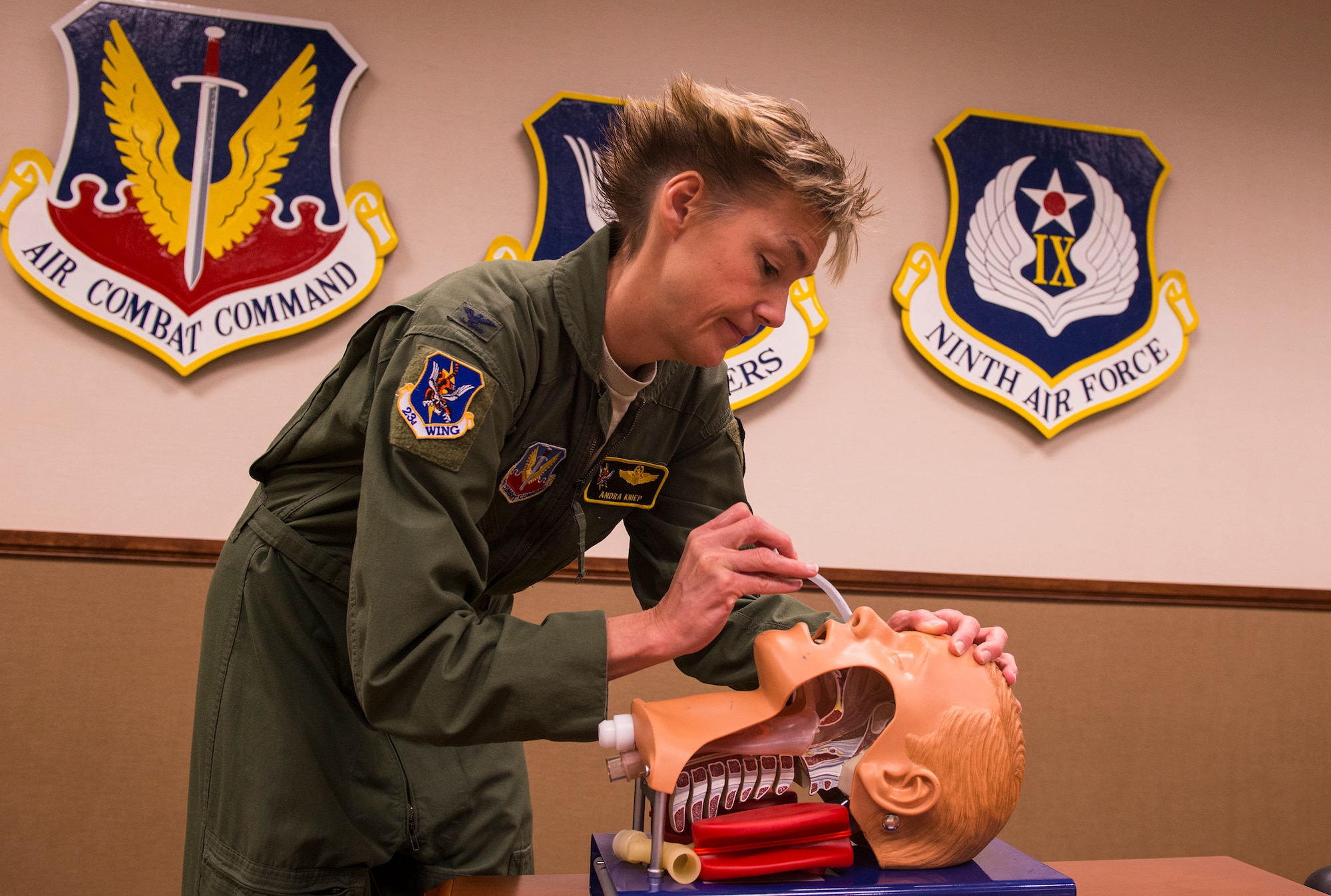 U.S. Air Force Col. Andra Kniep, 23d Wing vice commander, inserts a nasopharyngeal airway (NPA) during a self-aid and buddy care class Feb. 25, 2015, at Moody Air Force Base, Ga. The NPA, jaw thrust and head tilt/chin lift are the three techniques used to secure an open airway. (U.S. Air Force photo by Airman 1st Class Ceaira Tinsley/Released)