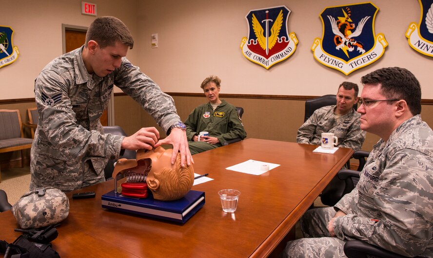 U.S. Air Force Senior Airman Jarrod Grammel, self-aid and buddy care instructor, demonstrates the proper way to insert a nasopharyngeal airway during a self-aid and buddy care class Feb. 25, 2015, at Moody Air Force Base, Ga. The class consisted of a lecture and hands-on training to ensure every Airman is certified to perform SABC. (U.S. Air Force photo by Airman 1st Class Ceaira Tinsley/Released)