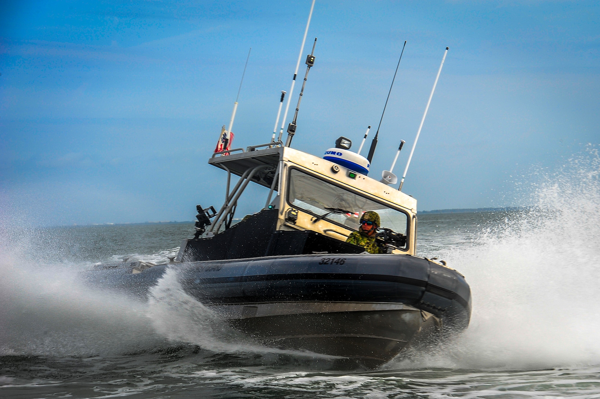 Members of the Port Security Unit 309 perform high-speed tactical boat maneuvers during a joint training exercise at MacDill Air Force Base, Fla., Feb. 26, 2015. The 309th worked with the 6th Security Forces Squadron marine patrol on various sustained force protection and port security tactics. (U.S. Air Force photo by Senior Airman Ned T. Johnston/Released)