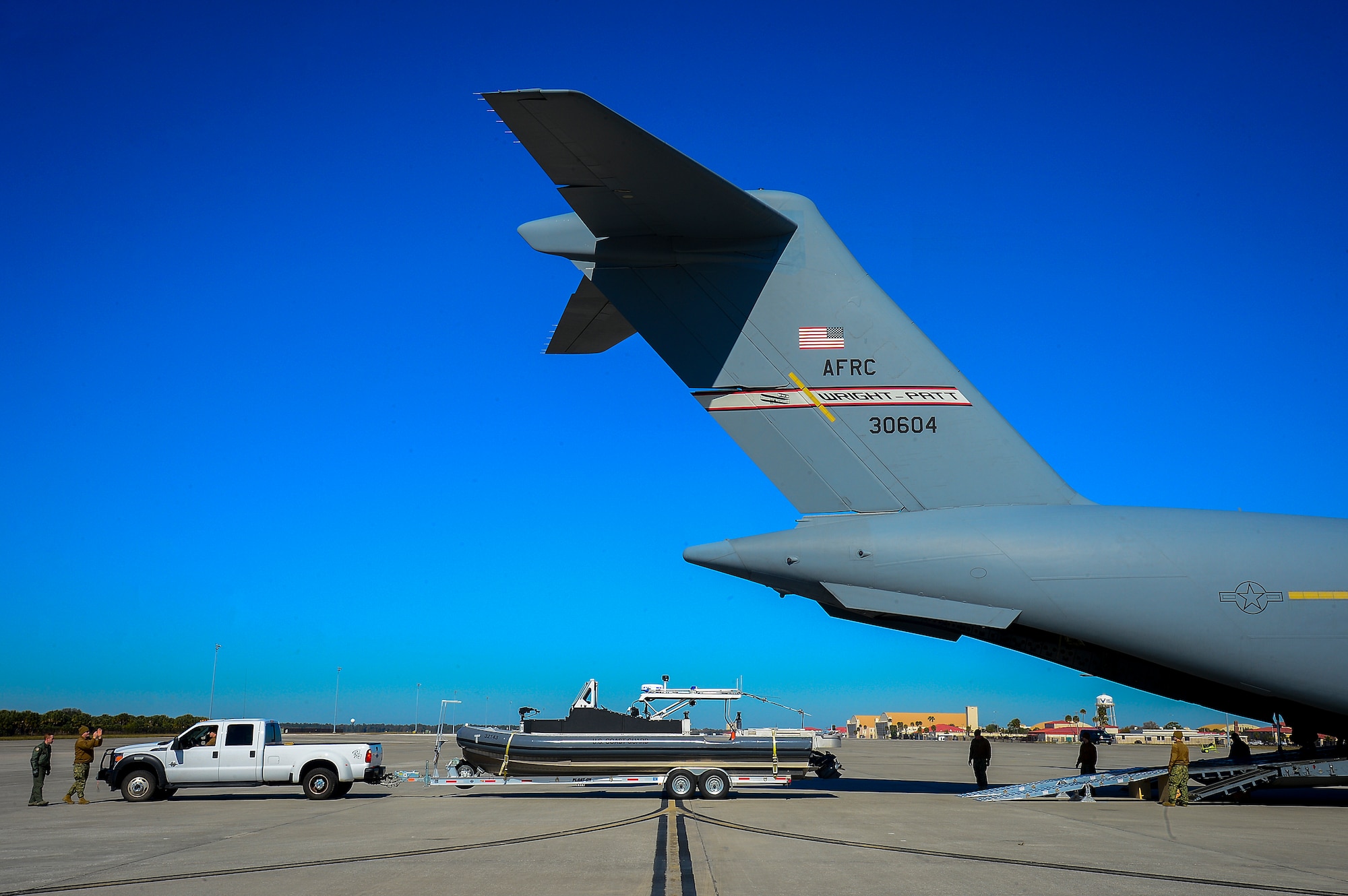 A Coast Guard 32-foot transportable port security boat is loaded into a C-17 Globemaster III at MacDill Air Force Base, Fla., Feb. 20, 2015. The 6th Air Mobility Wing hosted two Coast Guard exercises for the Port Security Unit 309 from Feb. 18 through March 1, 2015. (U.S. Air Force photo by Senior Airman Ned T. Johnston/Released)
