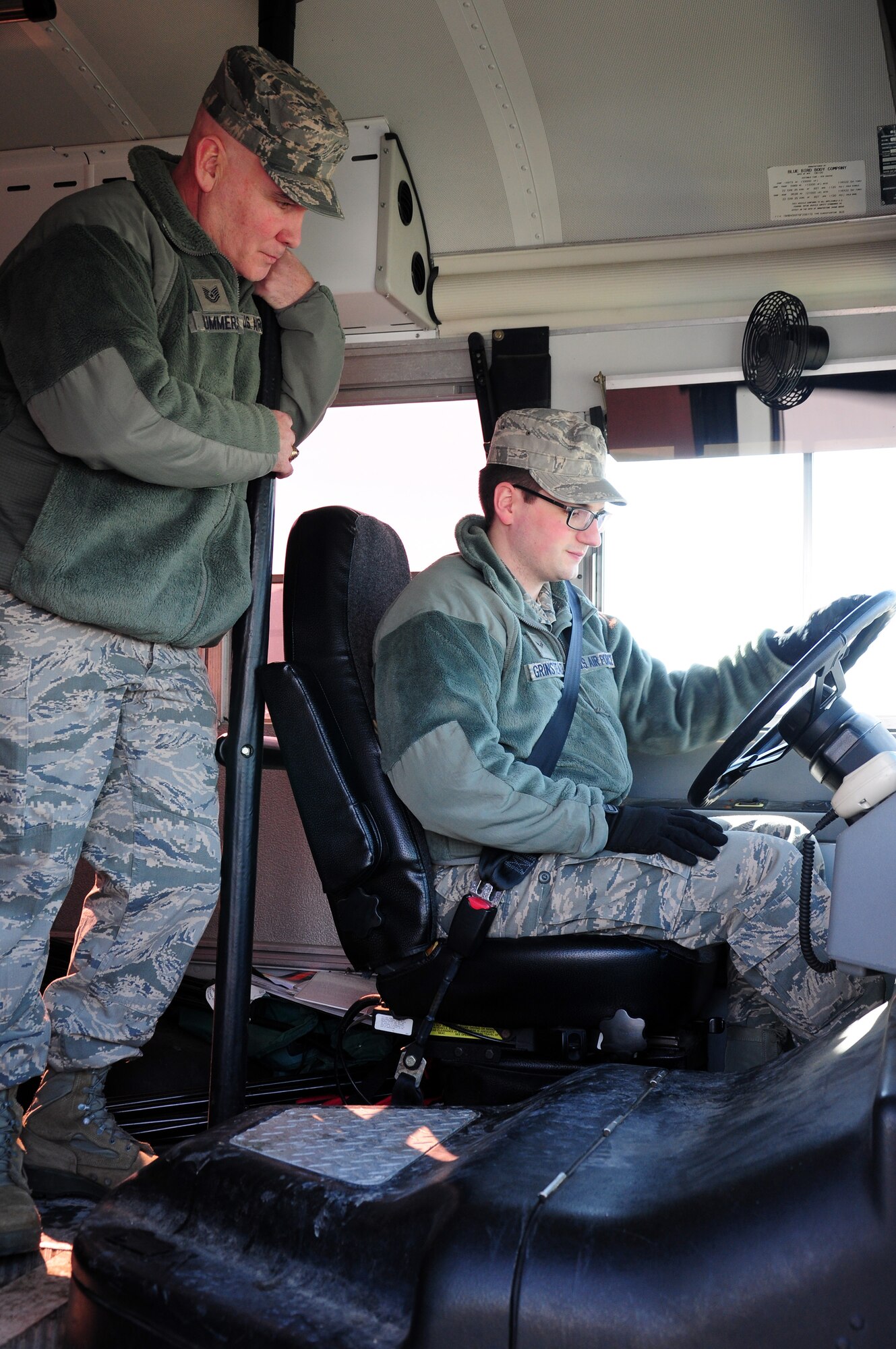 WRIGHT-PATTERSON AIR FORCE BASE, Ohio – Tech. Sgt. Michael Summers, 445th Aeromedical Staging Squadron pharmacy craftsman, instructs Airman 1st Class Ryan Grinstead, 445 ASTS aerospace medicine services journeyman, on driving procedures as part of his Airfield Driving course conducted using an Ambulance Bus during the Feb. 7, unit training assembly.  The course better prepares ASTS personnel on how to transport patients to and from an aircraft on the flightline. (U.S. Air Force photo/Tech. Sgt. Patrick O'Reilly)