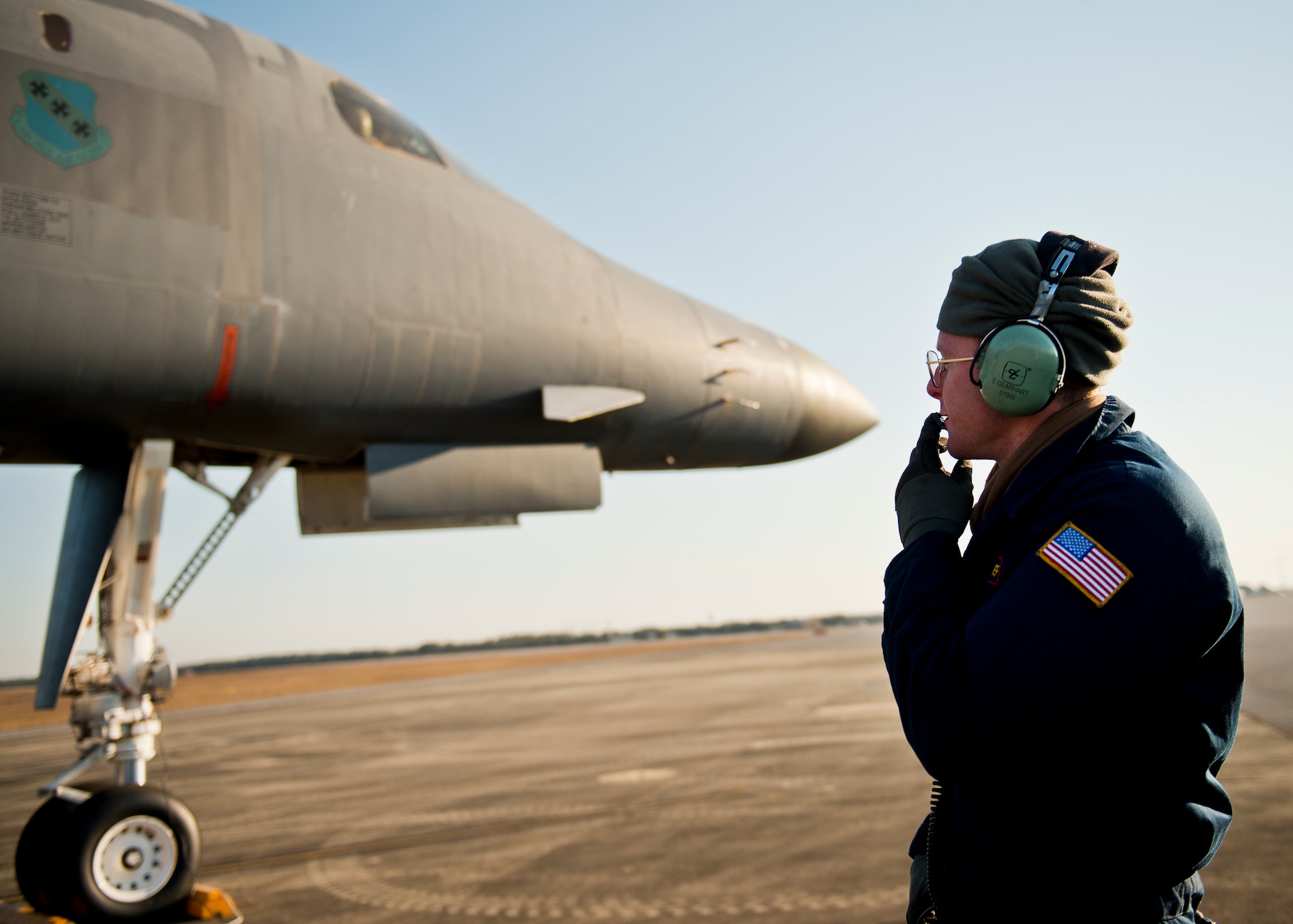 Senior Airman Sam Gearhart, 337th Test and Evaluation Squadron, communicates with the B-1B Lancer aircrew during preflight checks Feb. 20 at Eglin Air Force Base, Fla.  The 53rd Wing bomber from Dyess AFB, Texas was here for a few missions and to allow wing personnel an opportunity to see one of their geographically separated aircraft up close. (U.S. Air Force photo/Samuel King Jr.)