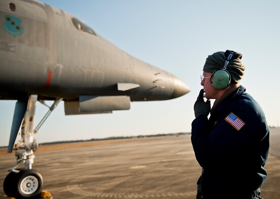 Senior Airman Sam Gearhart, 337th Test and Evaluation Squadron, communicates with the B-1B Lancer aircrew during preflight checks Feb. 20 at Eglin Air Force Base, Fla.  The 53rd Wing bomber from Dyess AFB, Texas was here for a few missions and to allow wing personnel an opportunity to see one of their geographically separated aircraft up close. (U.S. Air Force photo/Samuel King Jr.)