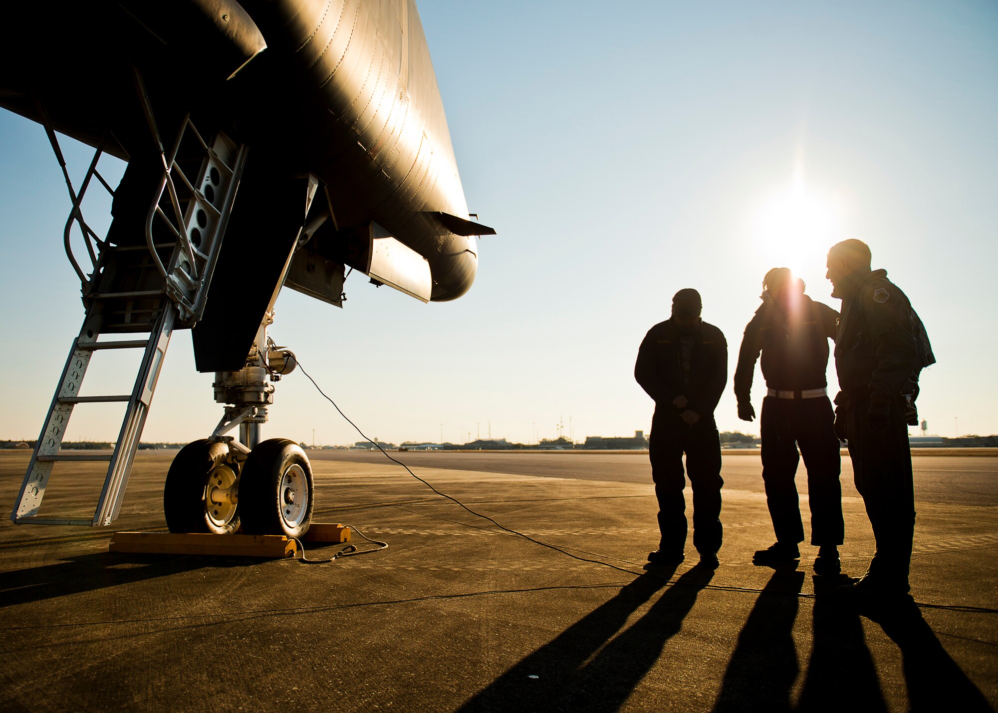 The sun rises over B-1B Lancer maintainers and aircrew Feb. 20 at Eglin Air Force Base, Fla.  The 53rd Wing bomber from Dyess AFB, Texas was here for a few missions and to allow wing personnel an opportunity to see one of their geographically separated aircraft up close. (U.S. Air Force photo/Samuel King Jr.)