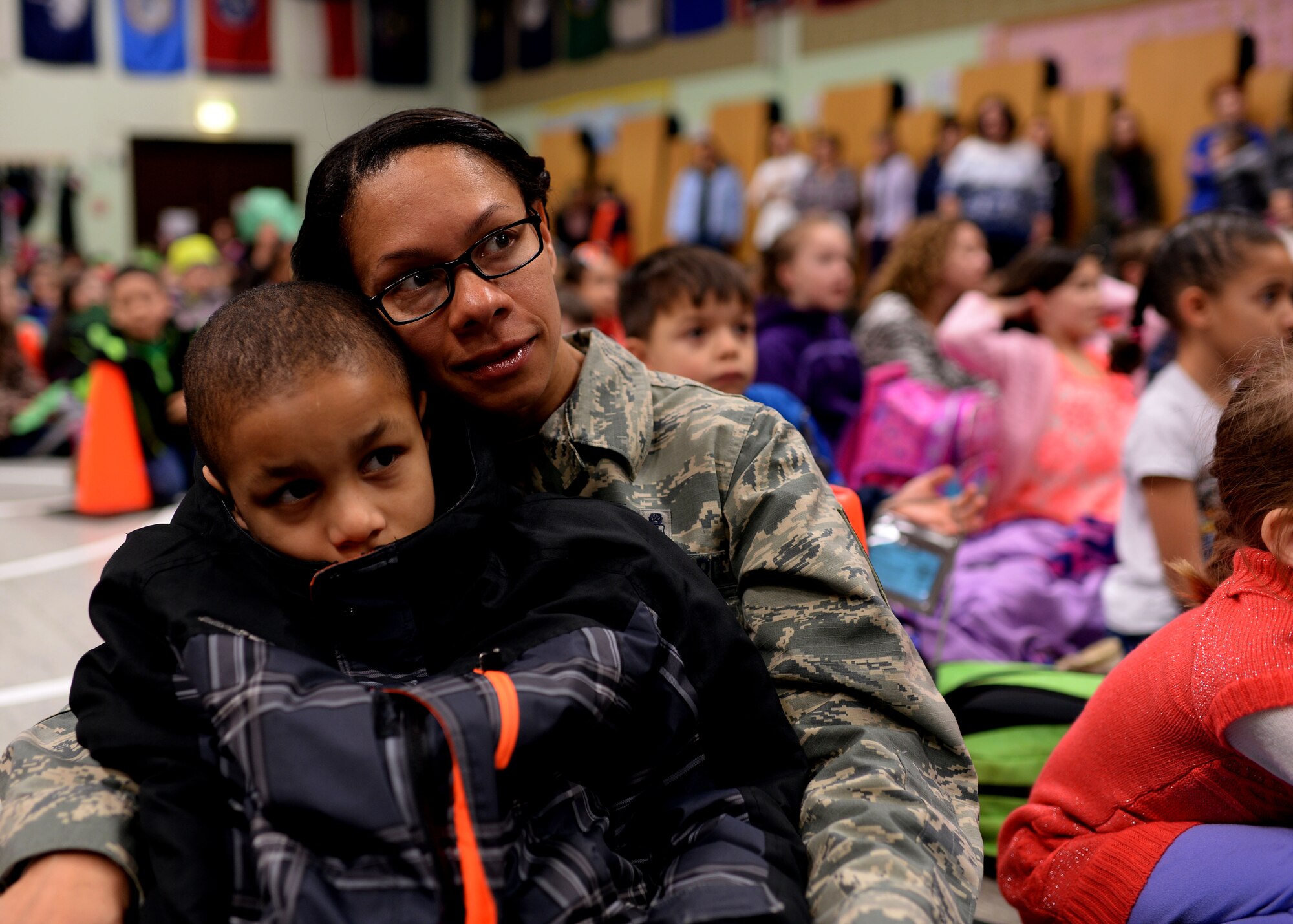 U.S. Air Force Master Sgt. Nicole Dismute, 52nd Medical Support Squadron, and her son, Isaiah, listen as U.S. Air Force Chief Master Sgt. Brian Gates, 52nd Fighter Wing command chief, read “Green Eggs and Ham” by children’s author Dr. Seuss during a Read Across America event March 2, 2015, in the elementary school at Spangdahlem Air Base, Germany. Wing leadership will visit the school throughout the week to highlight the importance of reading. (U.S. Air Force photo by Staff Sgt. Daryl Knee/Released)