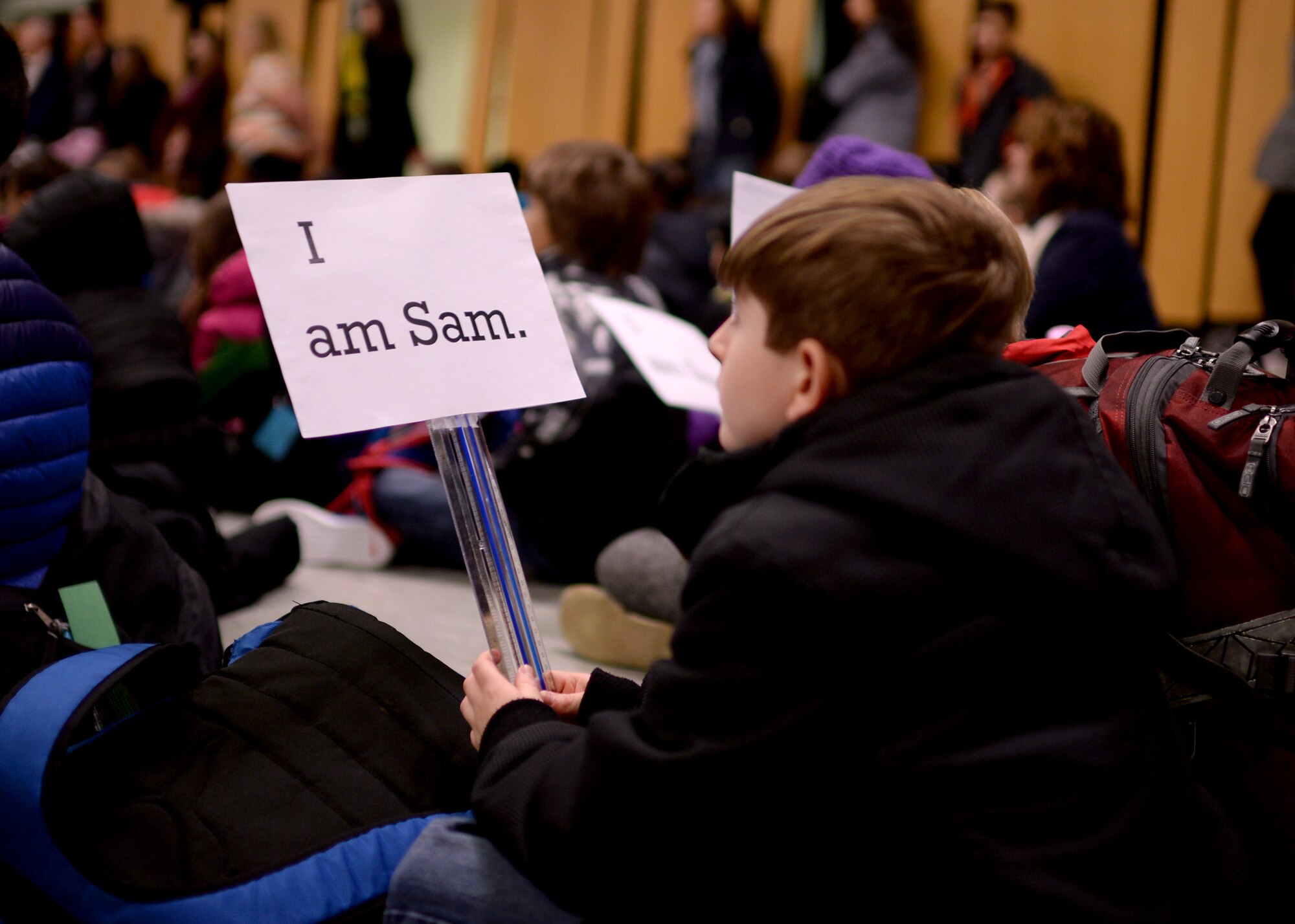 A student holds a sign for a Read Across America event in Spangdahlem Elementary School March 2, 2015, at Spangdahlem Air Base, Germany. U.S. Air Force Chief Master Sgt. Brian Gates, 52nd Fighter Wing command chief, read “Green Eggs and Ham” to the assembly — during specific parts of the story, the students would hold up signs or shout phrases. (U.S. Air Force photo by Staff Sgt. Daryl Knee/Released)