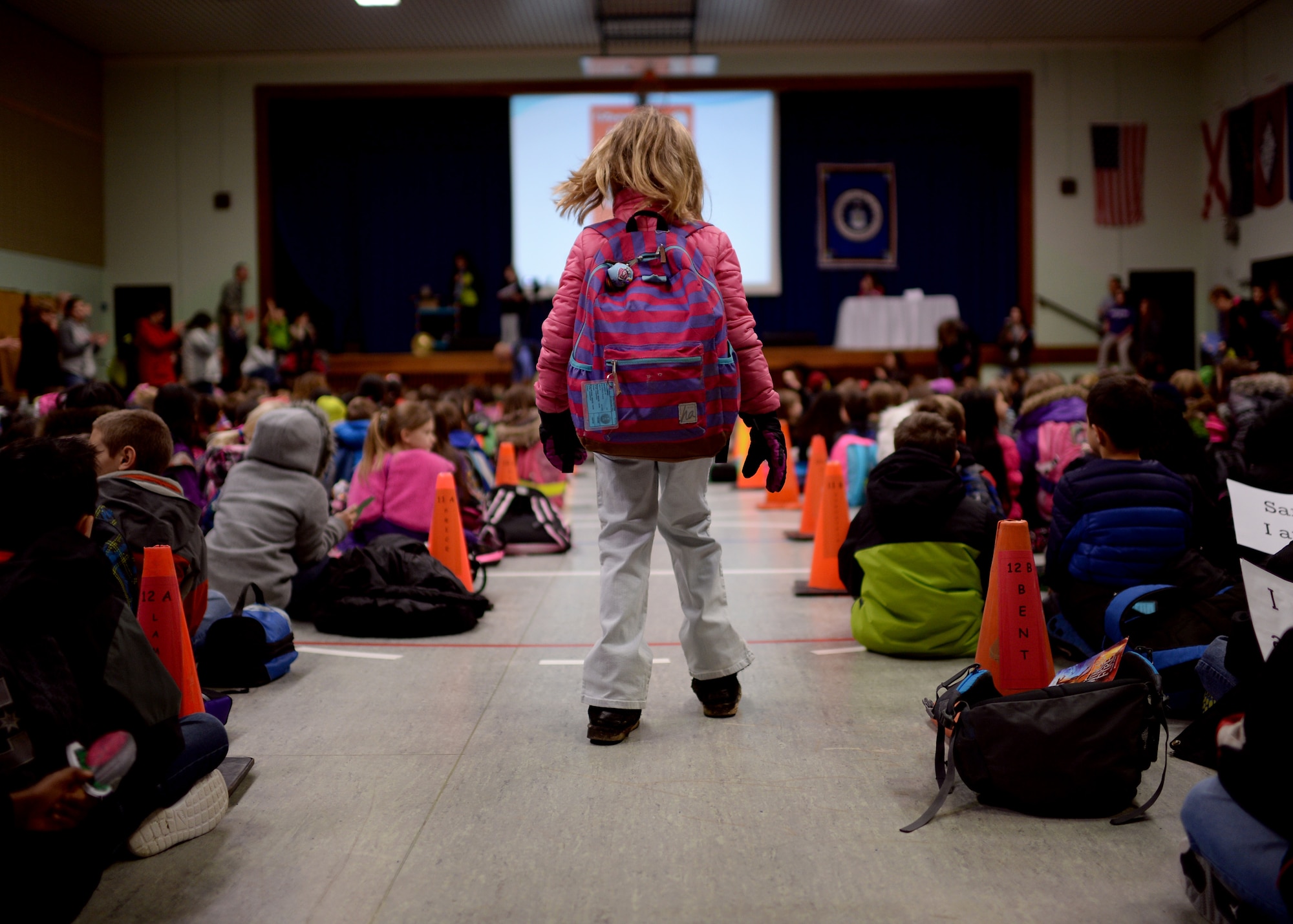 Kaelyn Wims, a second-grade student at Spangdahlem Elementary School, walks toward her class’ seating area before a Read Across America event March 2, 2015, at Spangdahlem Air Base, Germany. The day is sponsored by the National Education Association, and this year’s theme is “Oh the Places You’ll Go, when you read!” (U.S. Air Force photo by Staff Sgt. Daryl Knee/Released)