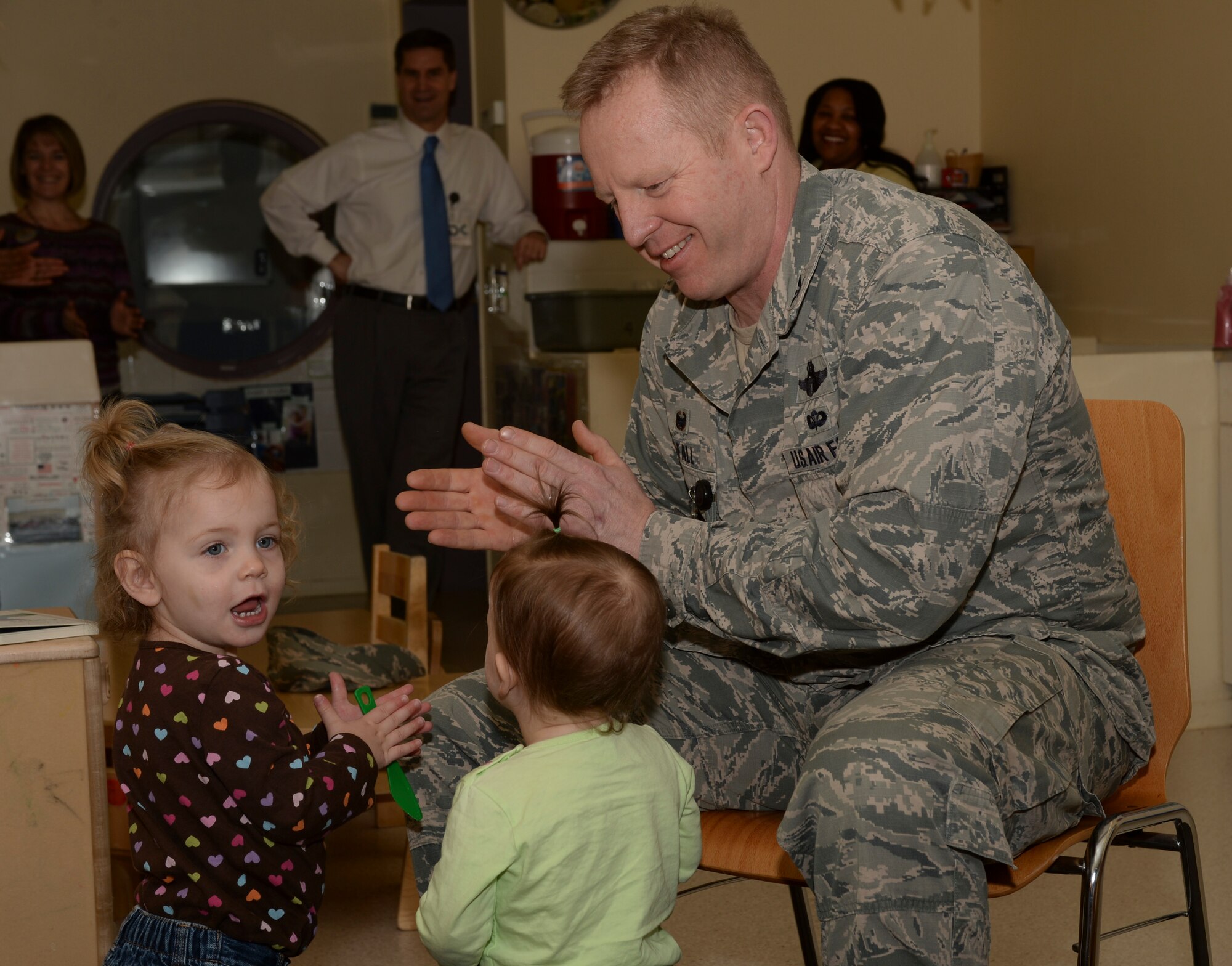 U.S. Air Force Col. Joe McFall, 52nd Fighter Wing commander, claps along with children at the conclusion of a Reading Across America event at a child development center at Spangdahlem Air Base, Germany, March 2, 2015. U.S. President Barack Obama signed a proclamation declaring March 2 as “Read Across America Day” and encouraged schools, libraries and families to participate in literacy-themed events. (U.S. Air Force photo by Staff Sgt. Joe W. McFadden/Released)