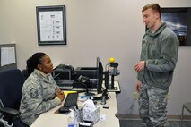 Master Sgt. Adaora Nwokoye, a customer service representative assigned to the 910th Military Personnel Flight (MPF), helps Staff Sgt. Aaron Fritz, a crew chief assigned to the 910th Aircraft Maintenance Squadron, with a Common Access Card (CAC) issue during the Unit Training Assembly here, Feb. 7, 2015. The MPF, part of the 910th Force Support Squadron, provides assistance with issuing a CAC, a military identification card, or working through technical concerns with the card. U.S. Air Force photo/Tech. Sgt. Valerie Smock.