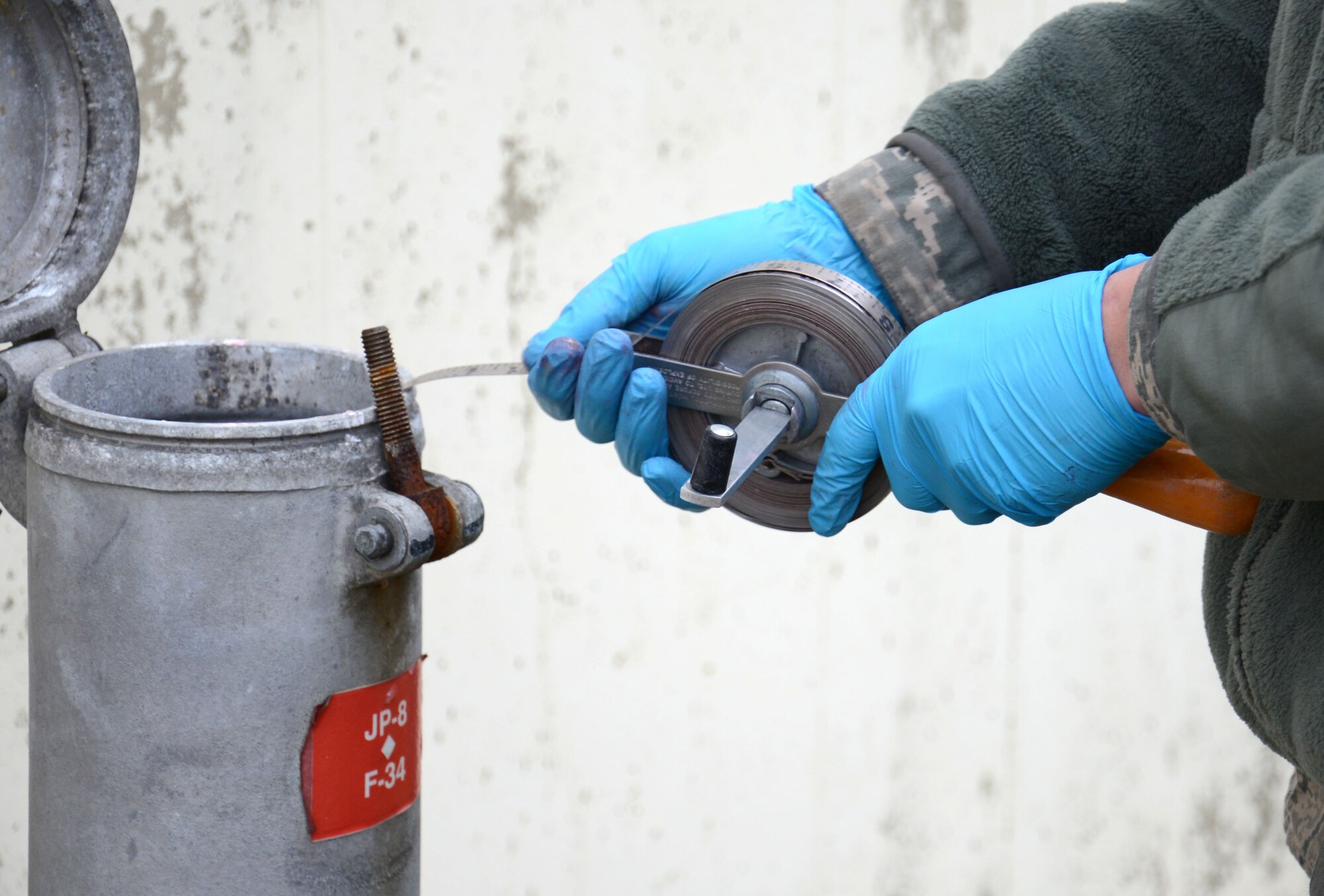 U.S. Air Force Airman 1st Class Daniel Lingefelt, 100th Logistics Readiness Squadron Fuels fixed facilities journeyman from Pendleton, S.C., verifies the fuel level in one of the base fuel tanks Feb. 11, 2015, on RAF Mildenhall, England. Lingefelt’s shop manually gauges the tanks quarterly to ensure the automatic tank gauging system is providing accurate readings for the fuel they control. (U.S. Air Force photo by Gina Randall/Released)