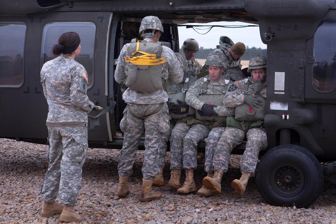 Paratroopers load onto a UH-60 Black Hawk helicopter before conducting a parachute jump over Saint Mere Eglise drop zone on Fort Bragg, N.C., Feb. 21, 2015.