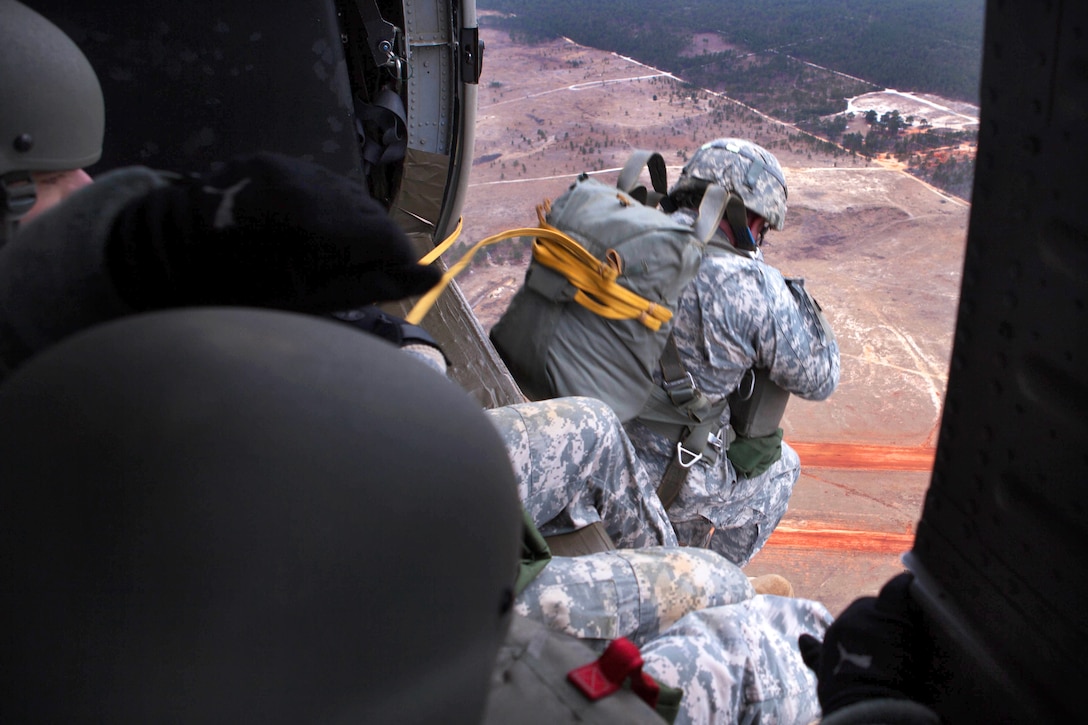 Paratroopers conduct a parachute jump using MC-6 parachutes and a UH-60 Black Hawk helicopter over Saint Mere Eglise drop zone on Fort Bragg, N.C., Feb. 21, 2015.