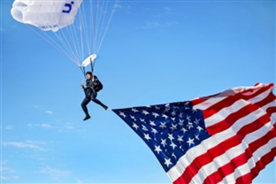 Air Force Cadet 1st Class Josh Burres flies the U.S. flag during an aerial demonstration for the opening ceremonies of the Air Force Wounded Warrior 2015 Trials on Nellis Air Force Base, Nev., Feb. 27, 2015. Burres is assigned to the 98th Flying Training Squadron.
