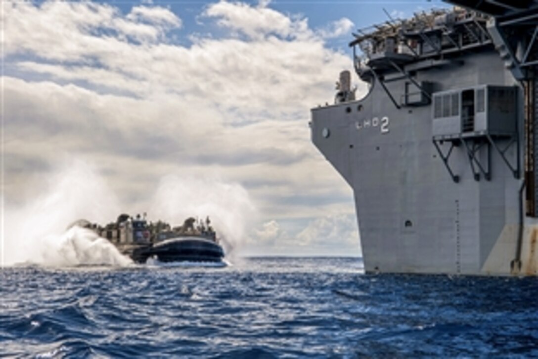 A landing craft air cushion enters the well deck of the amphibious assault ship USS Essex in the Pacific Ocean, March 1, 2015. The Essex is conducting an integration training exercise to prepare for an upcoming deployment. The landing craft air cushion is assigned to Assault Craft Unit 5.
