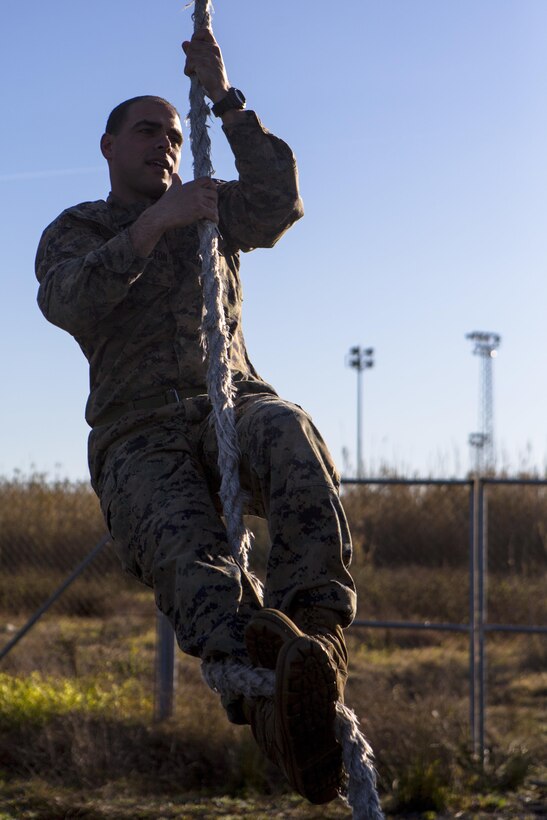 U.S. Marine Corps Staff Sgt. Rollie Pennington, a platoon sergeant with Special-Purpose Marine Air-Ground Task Force Crisis Response-Africa, demonstrates a rope-climbing technique on Rota Naval Base, Spain, Feb. 26, 2015. Marines with SPMAGTF-CR-AF completed an obstacle course to evaluate their physical fitness after a week of infantry-tactics training at the base. (U.S. Marine Corps photograph by Lance Cpl. Christopher Mendoza/Released)