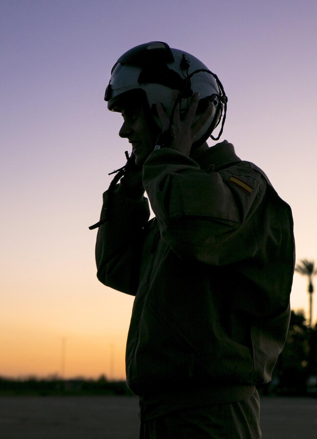 A Spanish pilot with Bhelma IV dons an aviator’s helmet before flying with U.S. Marines from Special-Purpose Marine Air-Ground Task Force Crisis Response-Africa at an airfield near Morón Air Base, Spain, Feb. 24, 2015. One Spanish pilot flew inside the Marines’ MV-22B Osprey, observing firsthand how the tiltrotor aircraft operated while flying with a Spanish helicopter from Bhelma IV. (U.S. Marine Corps photo by Sgt. Paul Peterson/Released)