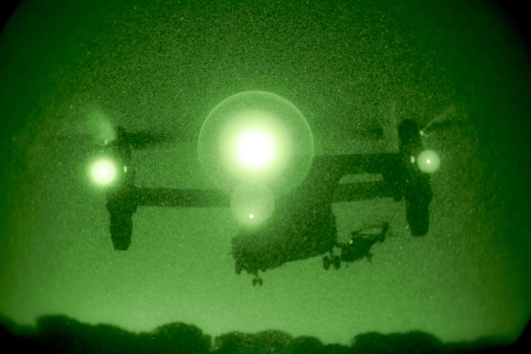An MV-22B Osprey with Special-Purpose Marine Air-Ground Task Force Crisis Response-Africa lands behind a Spanish helicopter from Bhelma IV during night training at an airfield near Morón Air Base, Spain, Feb. 24, 2015. NATO pilots’ ability to fly side by side under lowlight conditions increases their capacity to complete missions as a team, day or night. (U.S. Marine Corps photo by Sgt. Paul Peterson/Released)