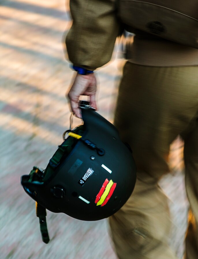 Spanish Capt. Alvaro Esteban, a pilot with Bhelma IV, carries his flight helmet before night training with U.S. Marine Corps MV-22B Osprey pilots from Special-Purpose Marine Air-Ground Task Force Crisis Response-Africa, at an airfield near Morón Air Base, Spain, Feb. 24, 2015. Esteban flew his Spanish helicopter in formation with the Marines’ tiltrotor Osprey, which completed several simultaneous night landings alongside the Spanish aircraft. (U.S. Marine Corps photo by Sgt. Paul Peterson/Released)
