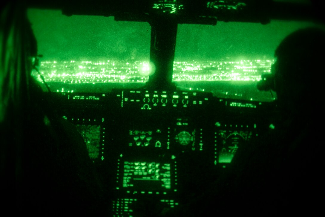 Spanish city lights sparkle through the window of a U.S. Marine Corps MV-22B Osprey from Special-Purpose Marine Air-Ground Task Force Crisis Response-Africa as it finishes a night training exercise with pilots from Spain’s Bhelma IV near Morón Air Base, Spain, Feb. 24, 2015. Pilots from the NATO nations completed a series of night landings to hone their capacity to operate as a cohesive team under the cover of darkness.  (U.S. Marine Corps photo by Sgt. Paul Peterson/Released)