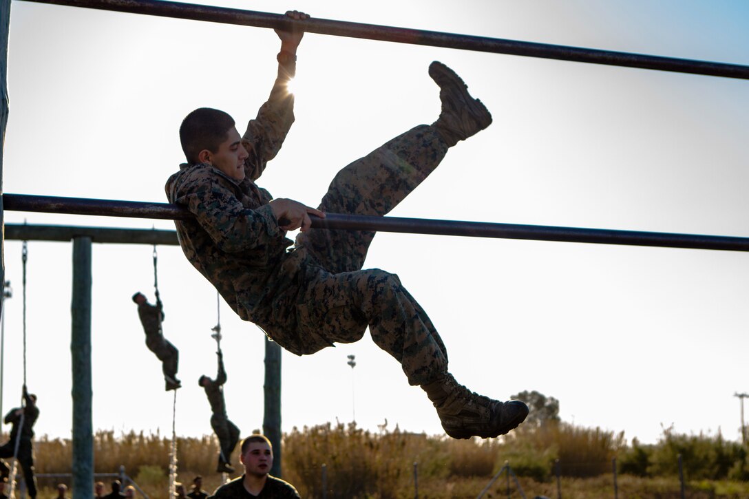 U.S. Marine Corps Lance Cpl. Duber Garzon, a rifleman with Special-Purpose Marine Air-Ground Task Force Crisis Response-Africa, climbs over parallel bars during an obstacle course on Rota Naval Base, Spain, Feb. 26, 2015. The Marines spent a week honing their infantry tactics during a series of field exercises before taking on the obstacle course to assess their physical fitness. (U.S. Marine Corps photograph by Lance Cpl. Christopher Mendoza/Released)