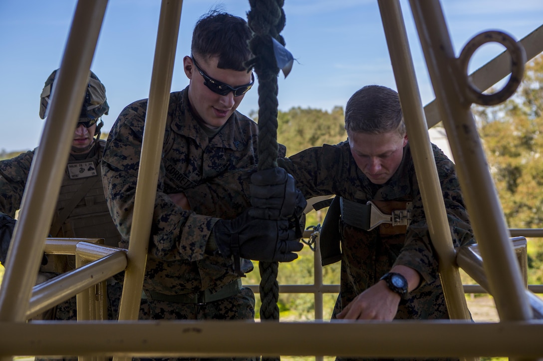 U.S. Marine Corps Cpl. Travis Corbett, left, a Marine with Special-Purpose Marine Air-Ground Task Force Crisis Response-Africa, left, prepares to fast rope down a tower on Rota Naval Base, Spain, Feb. 25, 2015. Marines maintain their fast-roping qualifications in order to remain proficient at fast roping out of hovering aircraft. (U.S. Marine Corps photograph by Lance Cpl. Christopher Mendoza/Released)